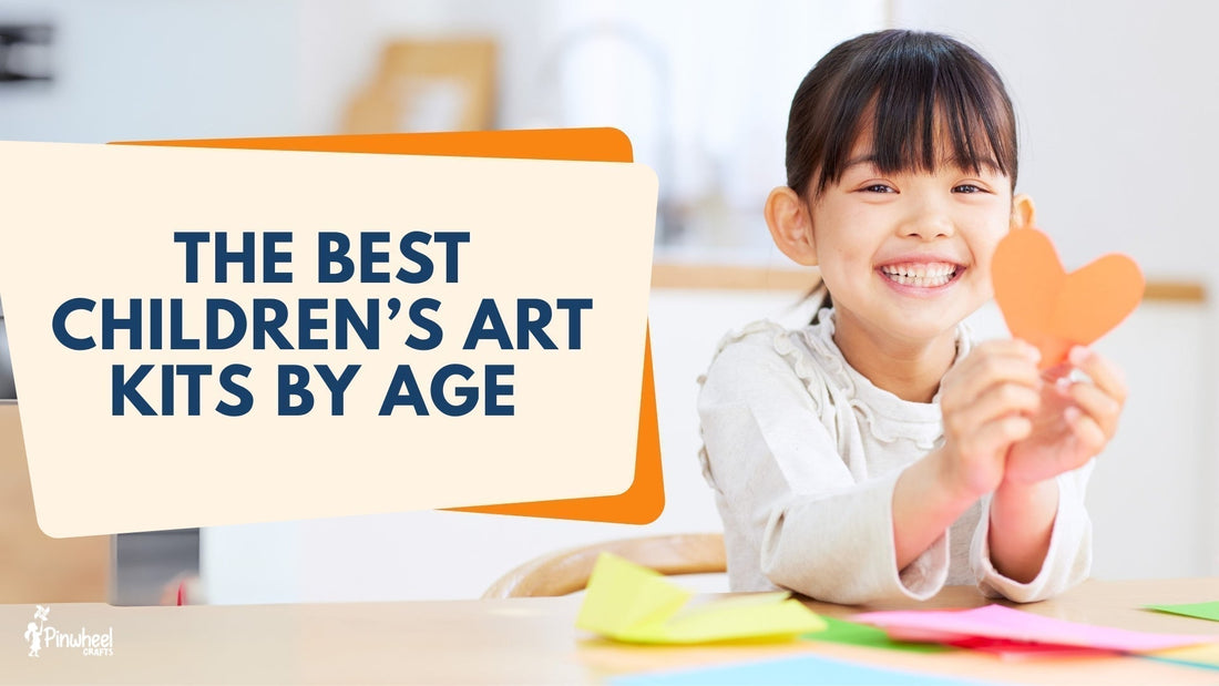 Smiling girl holding up her completed art project from children’s art kits