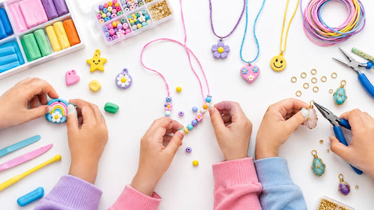 Children's hands making pendant necklaces: shaping a clay rainbow charm, threading beads onto cord, and wrapping wire around a stone with pliers.