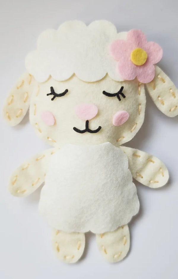 Finished felt lamb plushie with a pink flower, from the Bunny and Friends Sewing Kit