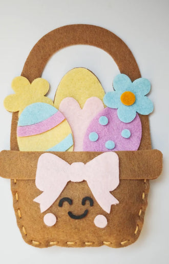 Finished felt egg basket with a bow and a smiling face, from the sewing kit