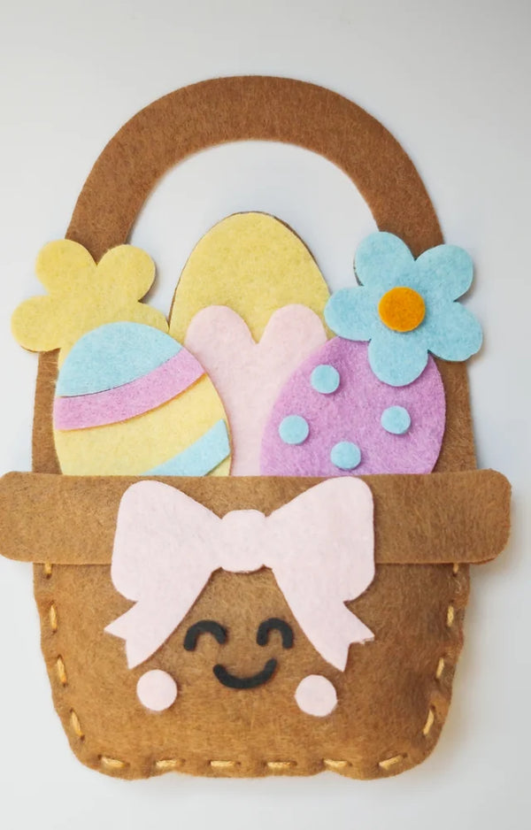 Finished felt egg basket with a bow and a smiling face, from the sewing kit