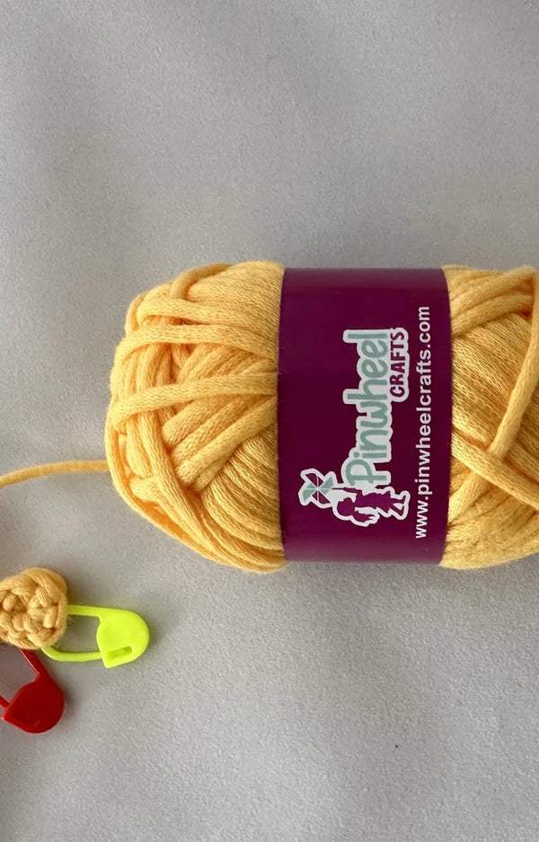 A second angle of the pre-started crochet piece and the yellow yarn from the Chirpy Chick kit