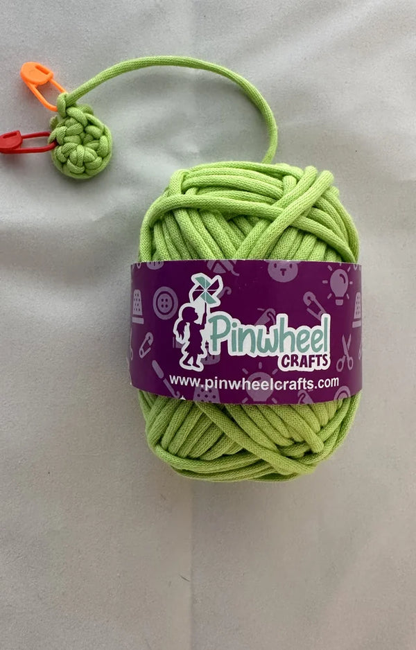The pre-started crochet piece on the green yarn from the Daring Dino crochet kit, close up