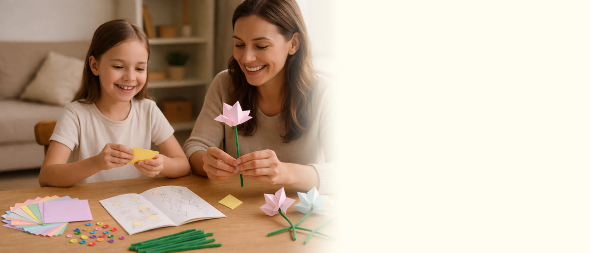 A girl and her mother smiling as they fold pastel paper tulips at a table with the book, paper and stems