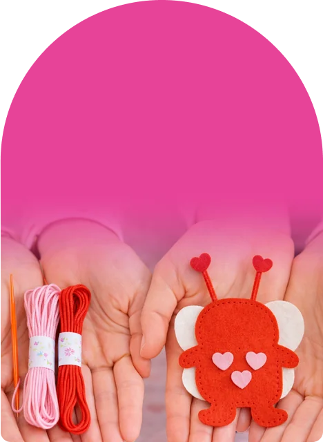 Two soft love bugs with heart antennae, googly eyes, and stitched edges