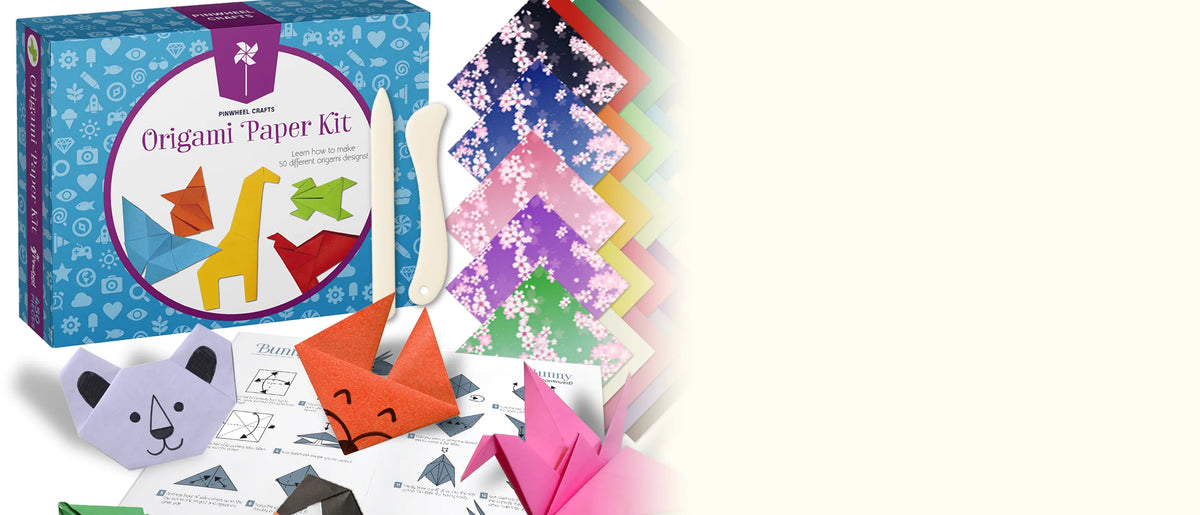 The Origami Paper Kit box with a white folding tool, fanned patterned papers and folded animal faces on white