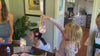 Kids at a party table hold up their finished fairy jars, lit from inside by the LED lids