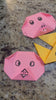 A girl opens the Origami Paper Kit at a table, reads the project book and folds colorful paper models
