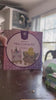 Two sisters paint and decorate mini canvases on wooden easels at the kitchen table while mom helps