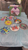 Kids unpack the kit and paint their mosaic stepping stones, then show all five finished stones