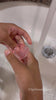 Two girls unmold their homemade sea life soaps, fold the mermaid gift box and wash their hands