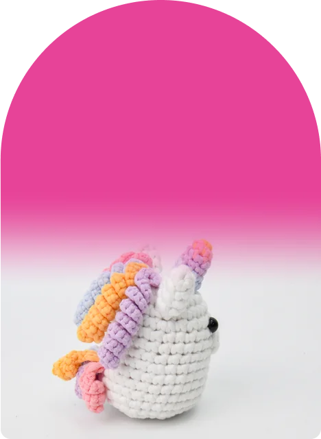 A rainbow horn and a curly rainbow mane on a round, cuddly body