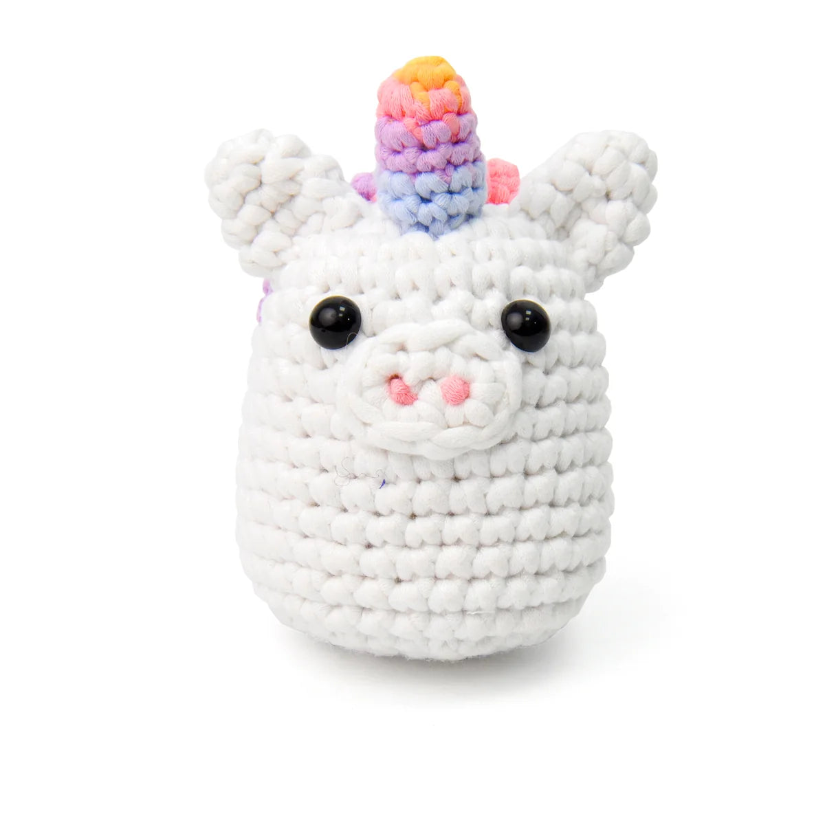 The finished crocheted rainbow unicorn with its rainbow horn and curly rainbow mane, close up