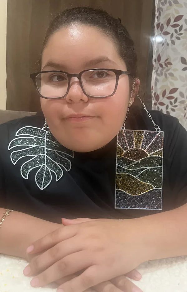 Girl holding the finished monstera leaf and sunset suncatchers