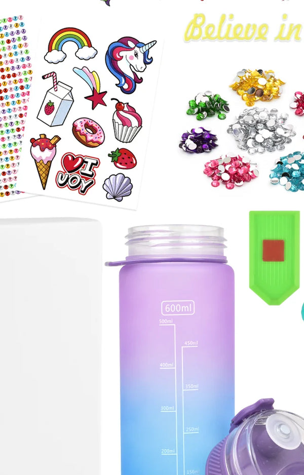 Unicorn and sweets stickers, gem piles, gem tray and the plain purple bottle before decorating