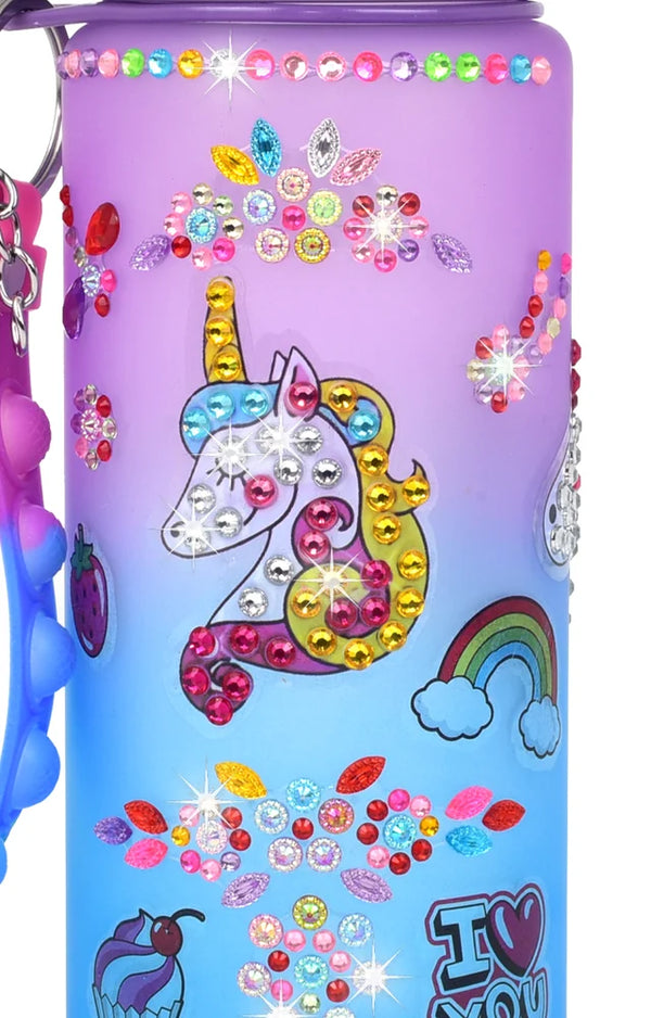 Purple and blue bottle covered in rhinestone flowers, a gem unicorn, a rainbow and an I love you sticker